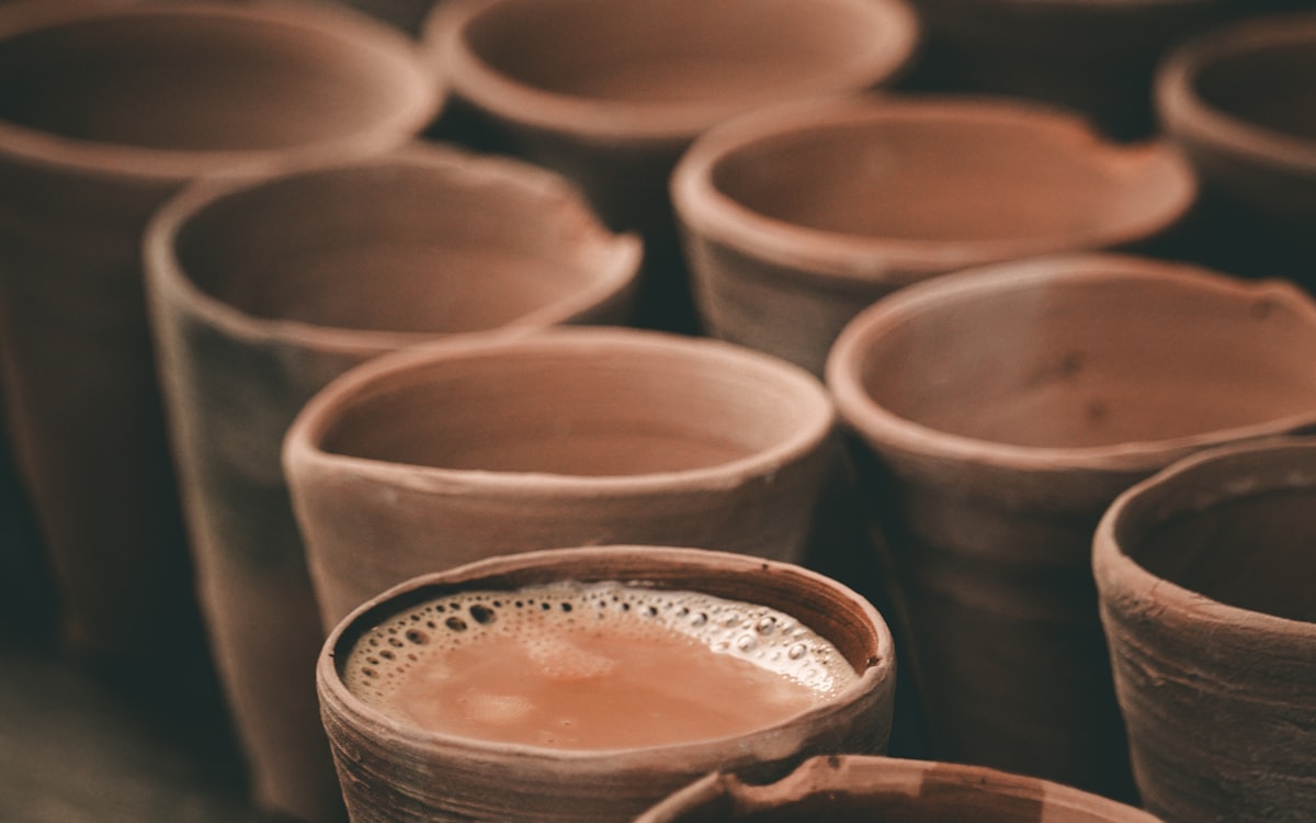 Kulhads of chai on a wooden table