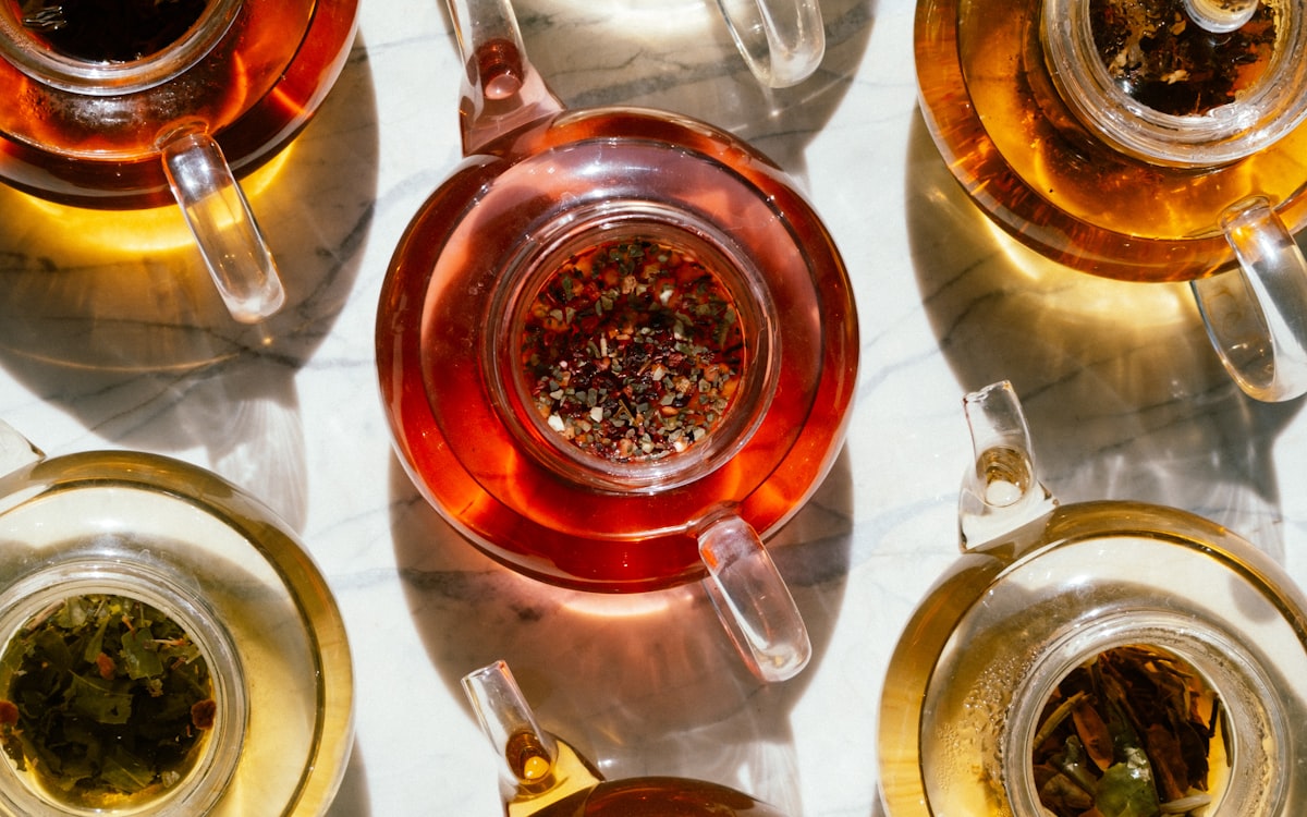 Glass teapots of green tea